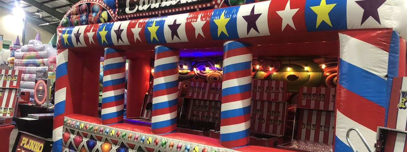 Row of grand carnival funfair stalls set up at an evening event