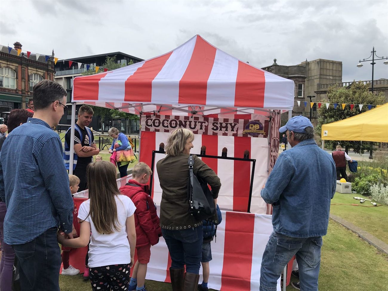 The striped coconut shy booth standing on a festival field