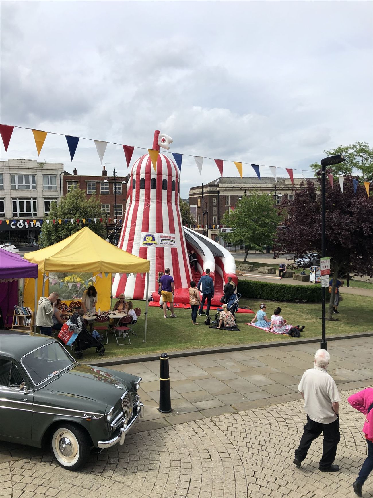 Helter skelter at a market square event with stallfronts and event traffic around it