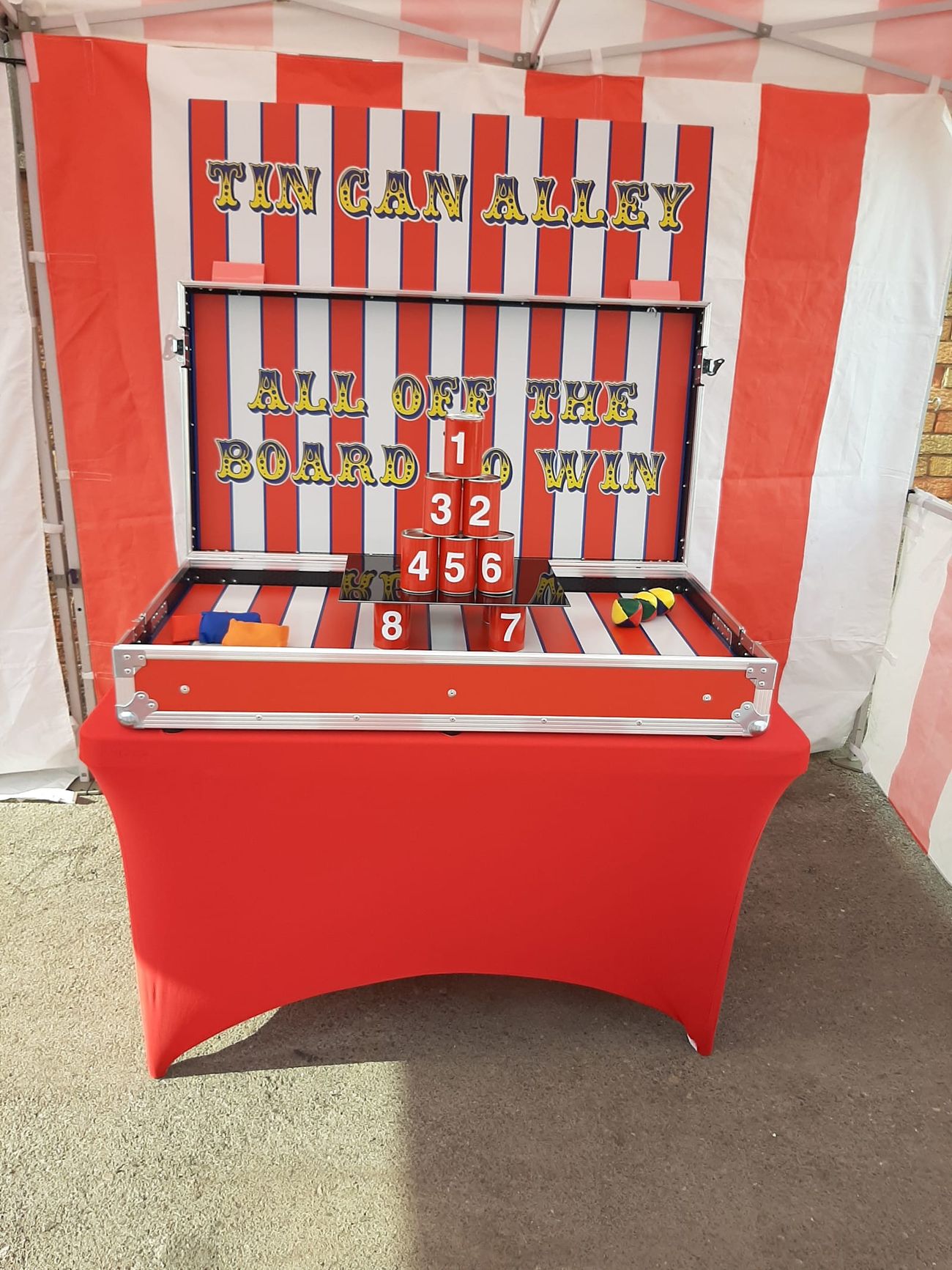 The Tin Can Alley case structure with its lid forming the backboard and cans stood on the playing surface